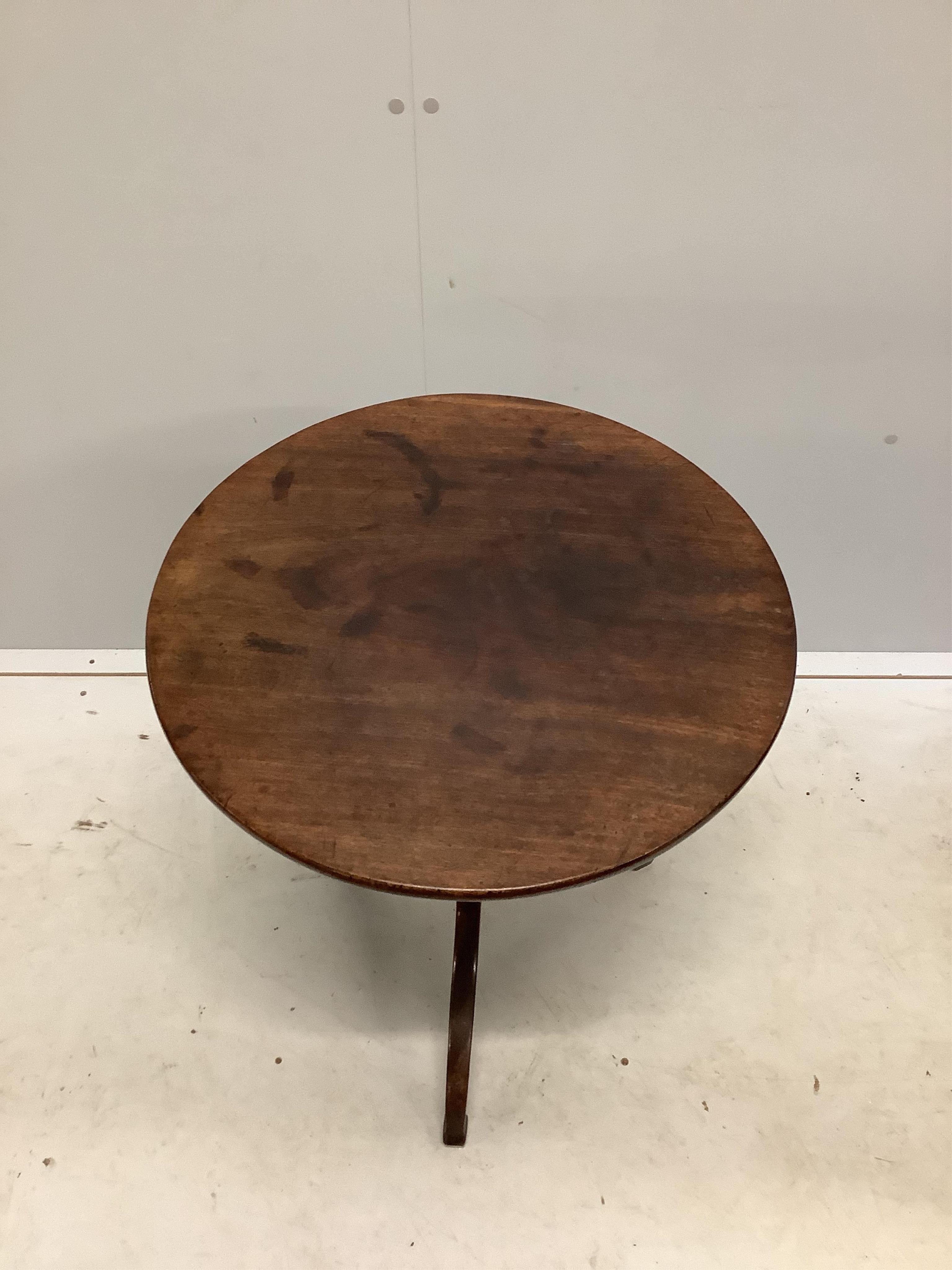 A George III circular mahogany tripod wine table, diameter 55cm, height 70cm. Condition - fair